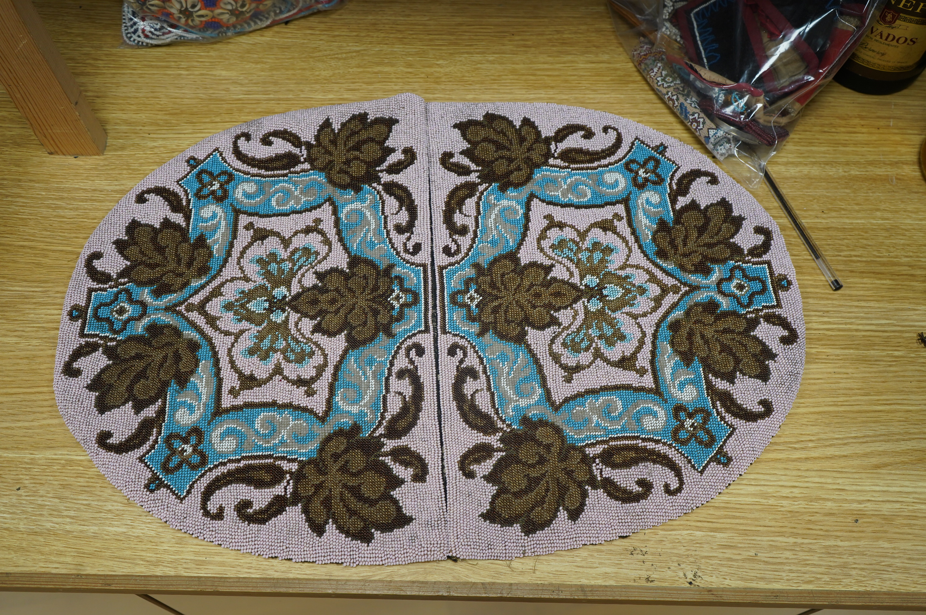 A 19th century unused Berlin beadwork tea cosy, worked in pink, turquoise, brown and white beads, beaded on two sides, the sides still joined. Ideal to convert as a cushion cover or two matching cushion covers, 55cm (tot